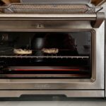New stainless steel replacement rack sliding into the guide rails of a Breville Smart Oven Pro BOV900BSS